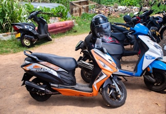 Several scooters are parked outside in a row.