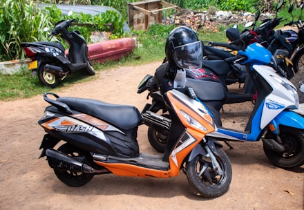 Several scooters are parked outside in a row.