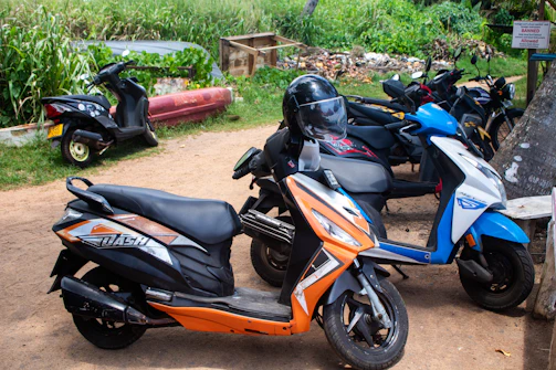 A line of scooters parked outdoors.