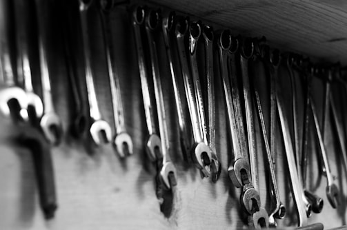 Wrenches hang neatly on a workshop wall.