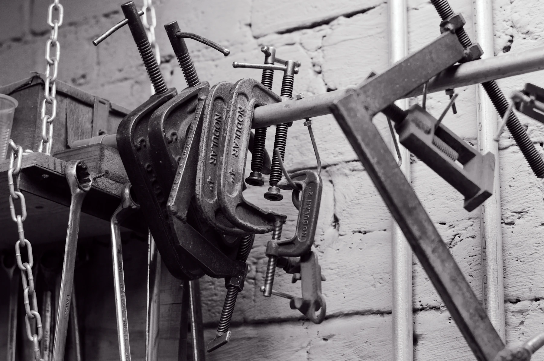 Metal clamps and workshop tools stored in an industrial repair workspace