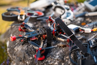 Drones and equipment are placed on a rock.