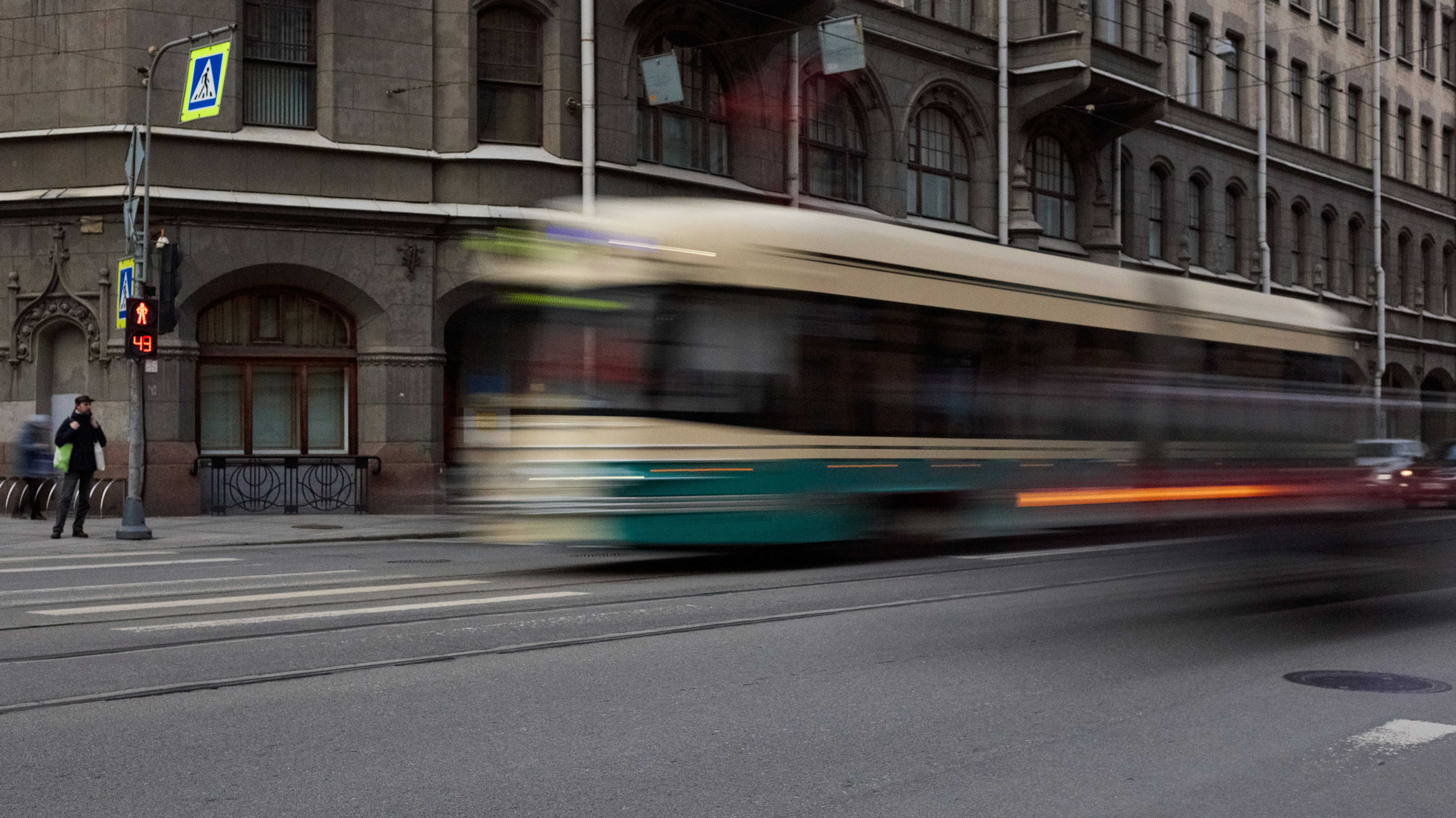 A bus speeds past the city buildings.