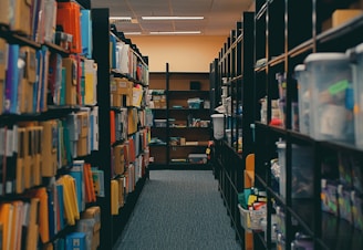Shelves filled with books line a library aisle.