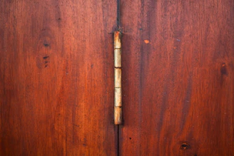 Wooden doors with a prominent hinge.