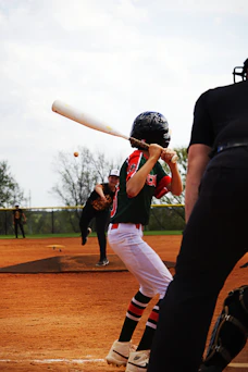 A baseball player hits a ball during a game