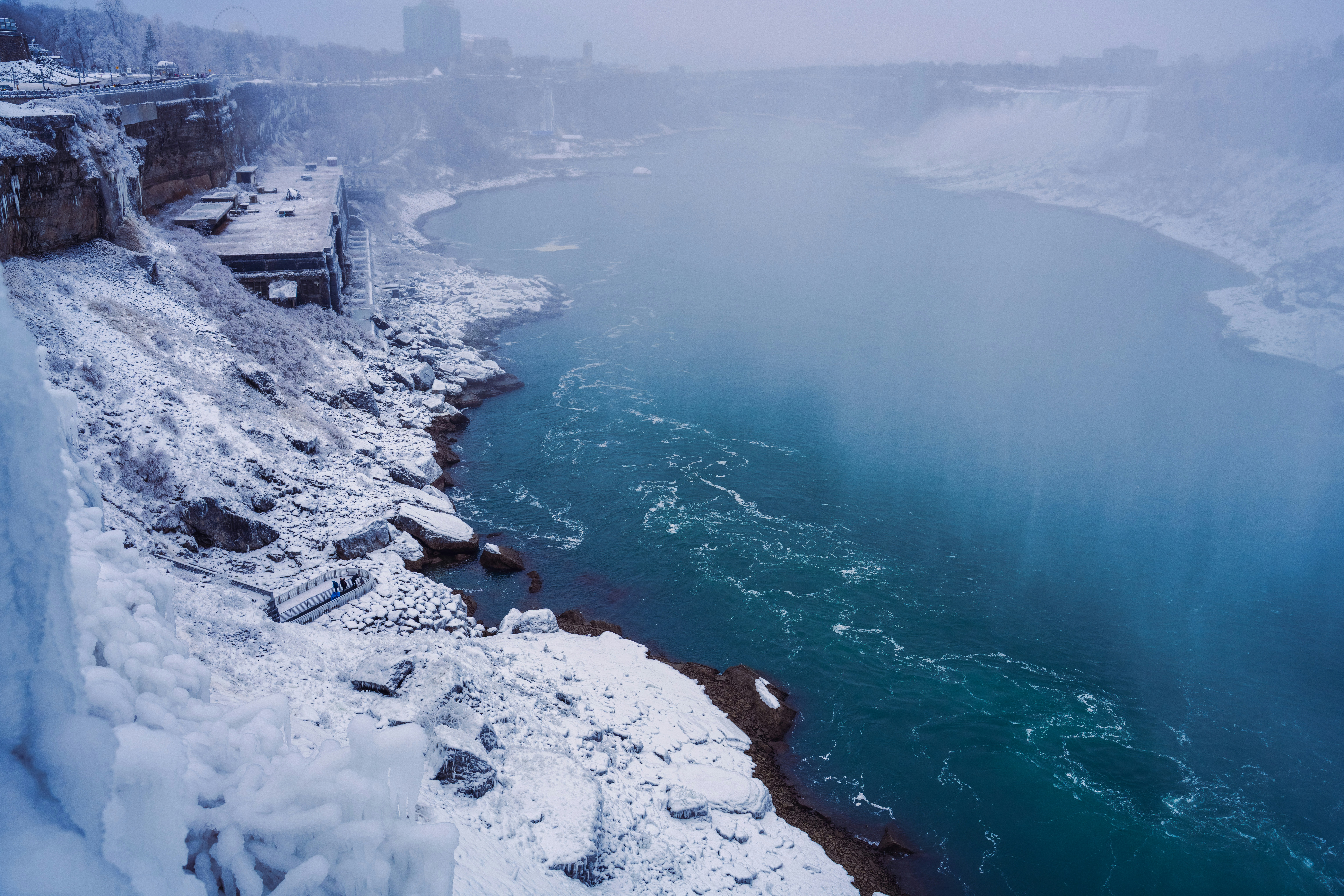 Niagara falls in winter, covered in snow.