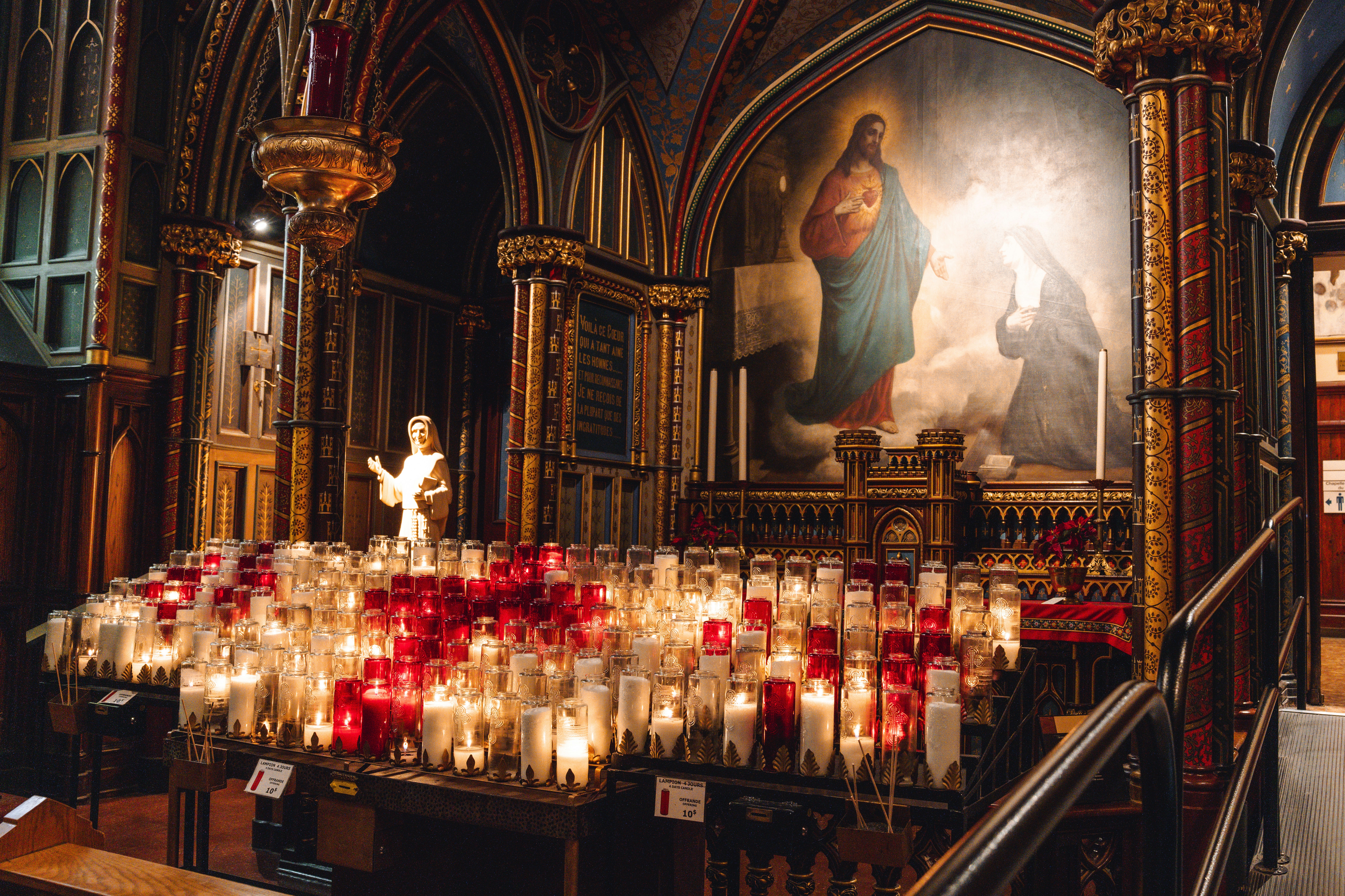 Candles illuminate a church interior with an icon.