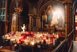 Candles illuminate a church interior with an icon.