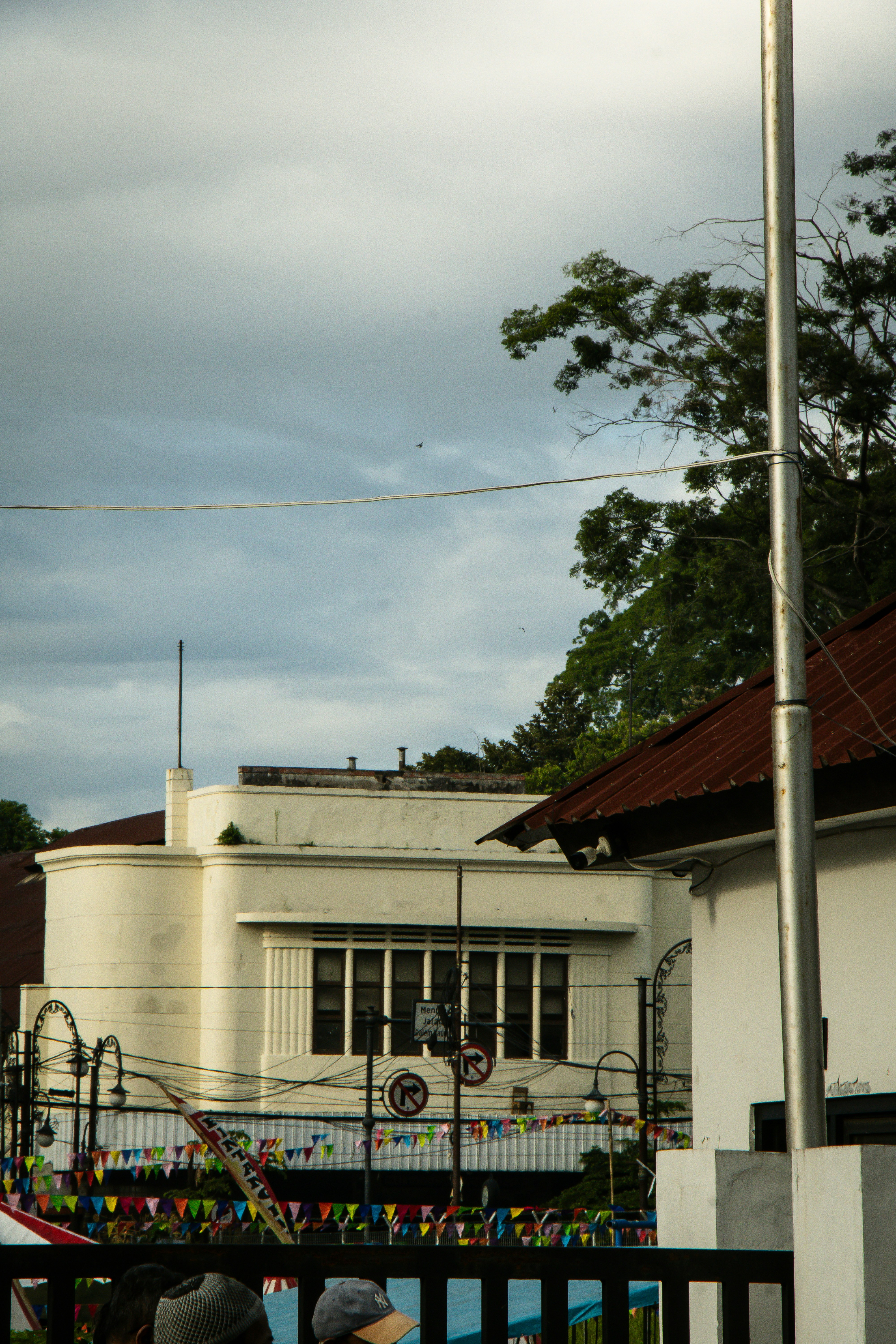 A white building stands beneath a cloudy sky.