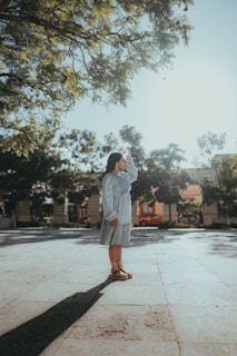 Woman shields her eyes from bright sunlight.
