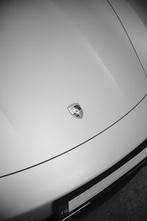 A porsche's hood featuring the logo.