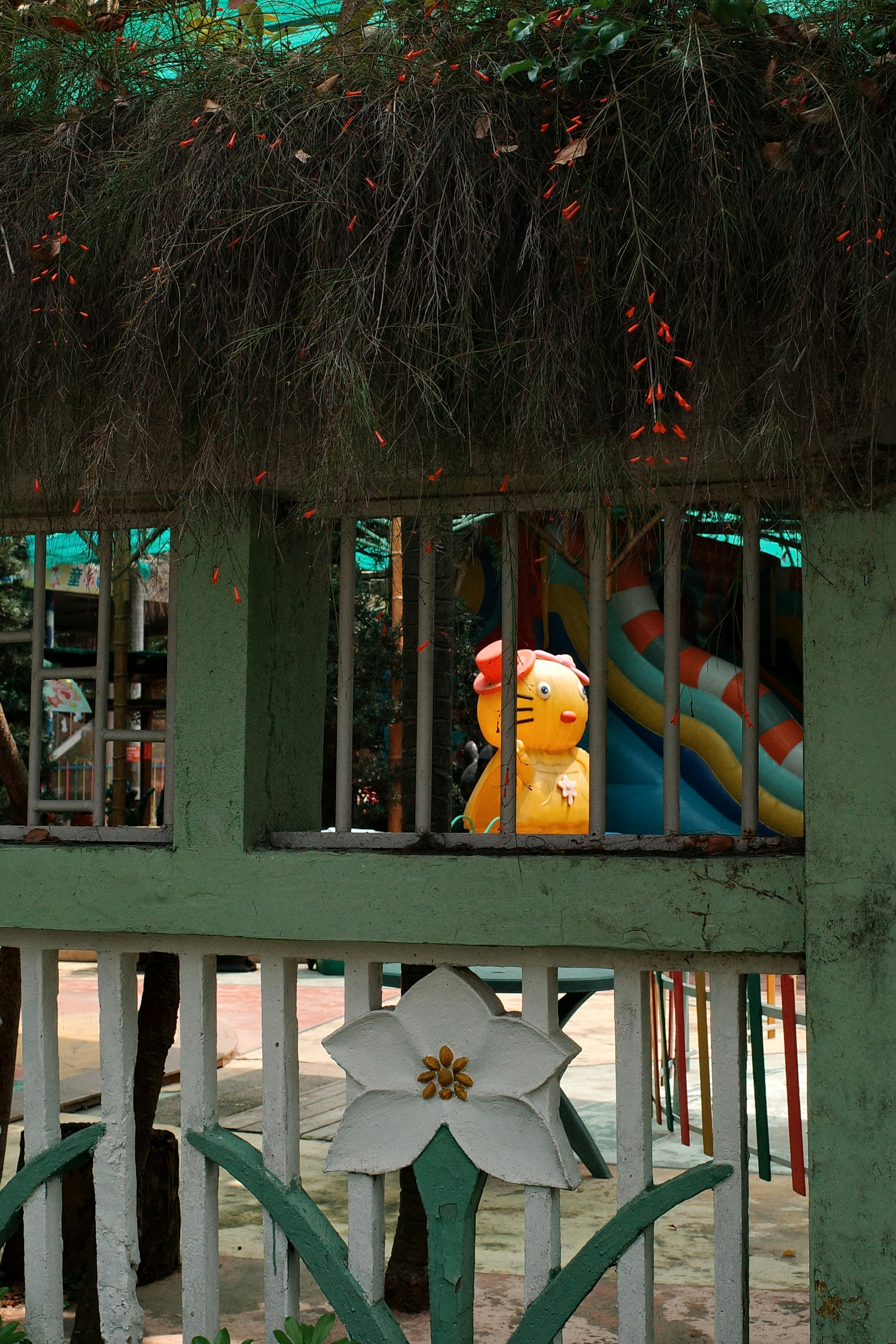 A bright yellow toy peeks out from the window.