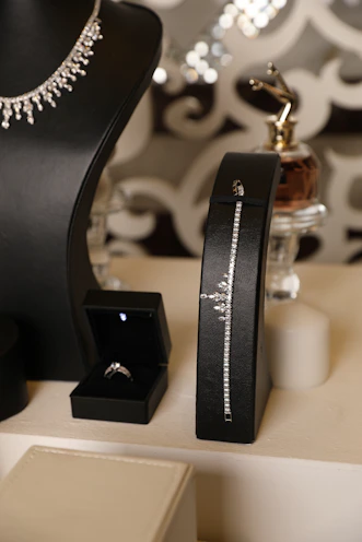 Jewelry display featuring diamonds, rings, and a necklace.