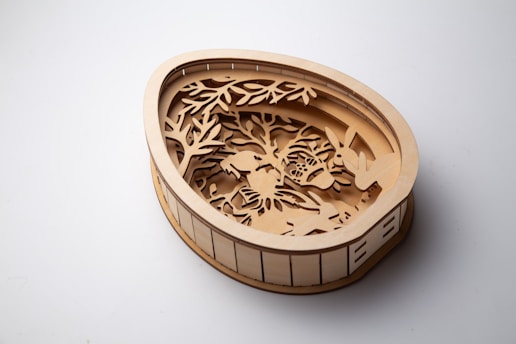 A wooden easter egg with a forest scene.