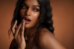 A woman poses, showing her makeup.