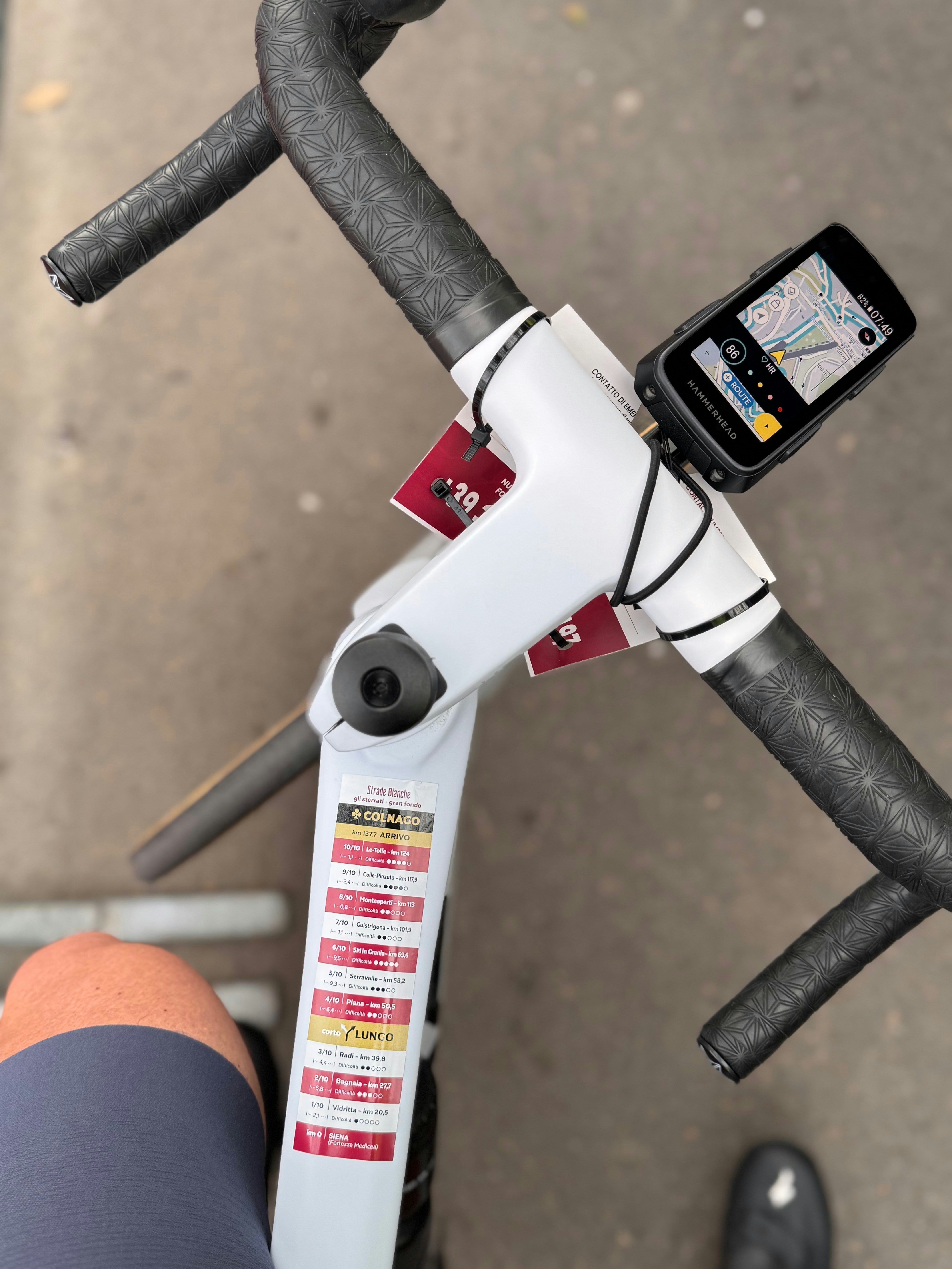 A road bike handlebar with gps attached.