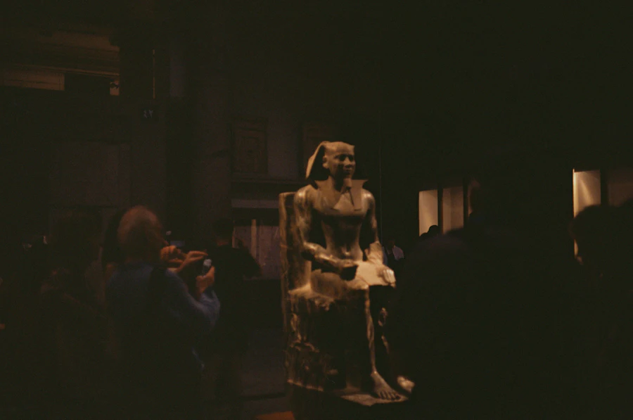A statue illuminated inside the Grand Egyptian Museum