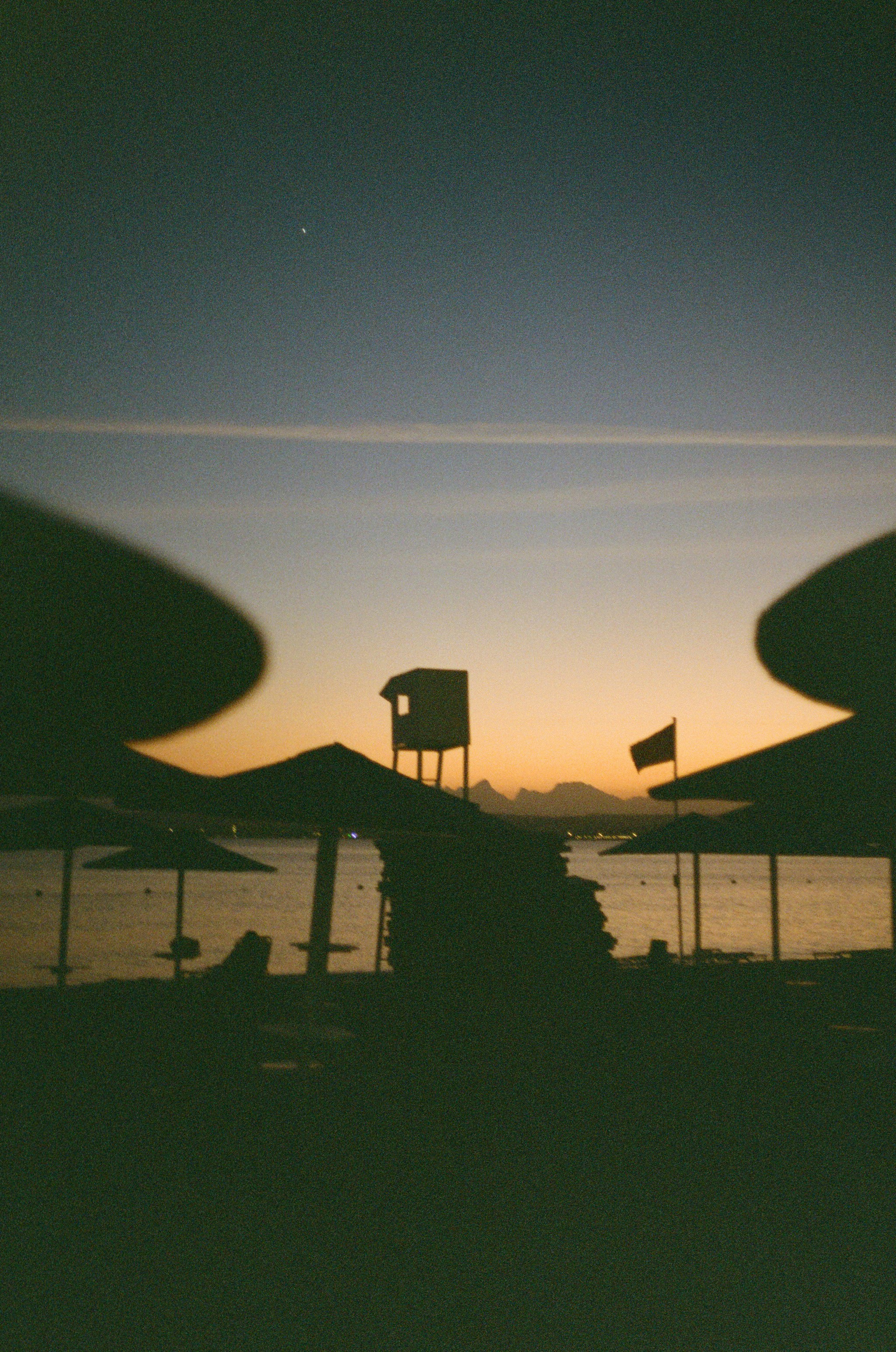 Beach silhouettes against a beautiful sunset sky