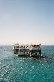 Boats and people enjoying a day at sea.
