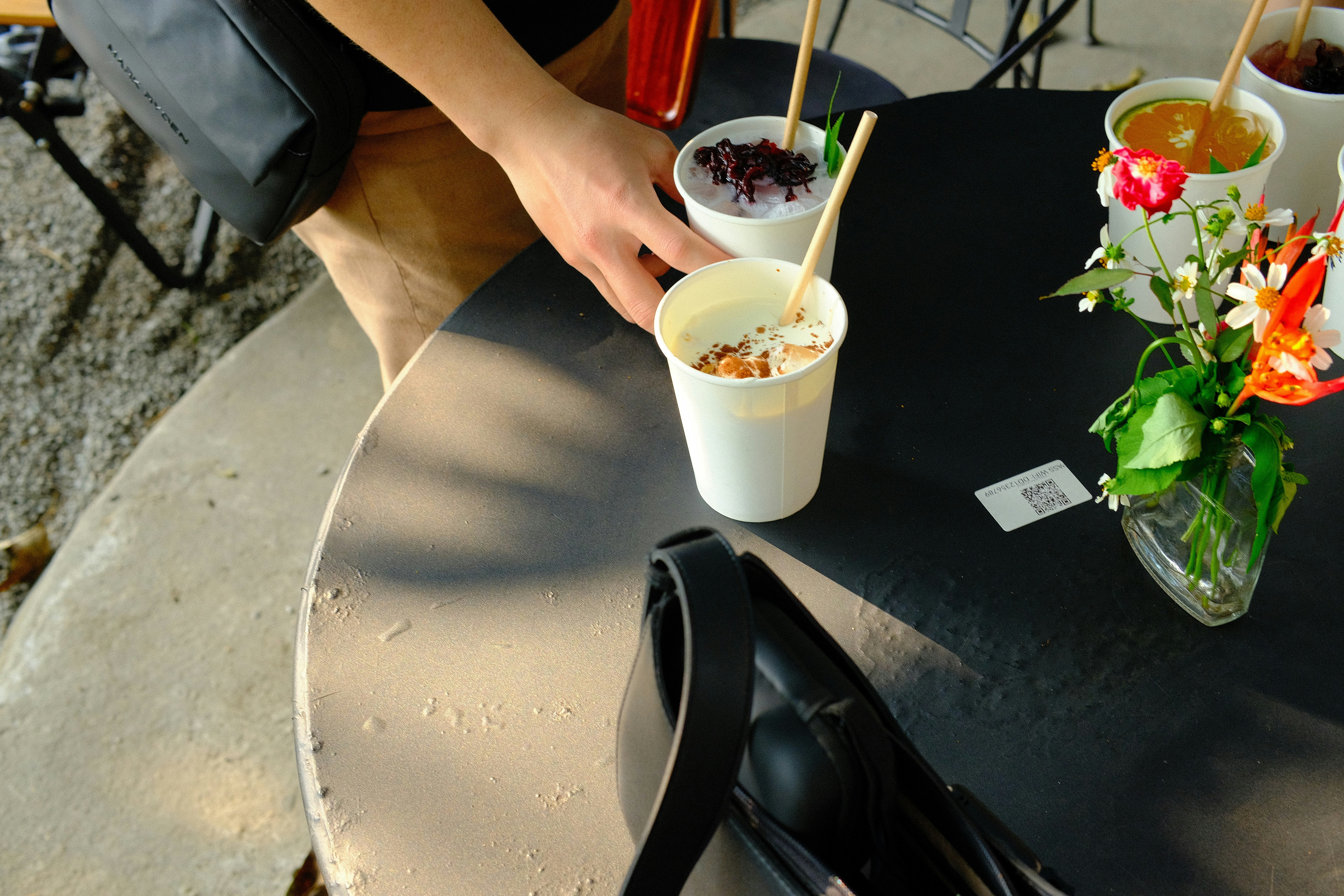 Someone is reaching for a cup of dessert.