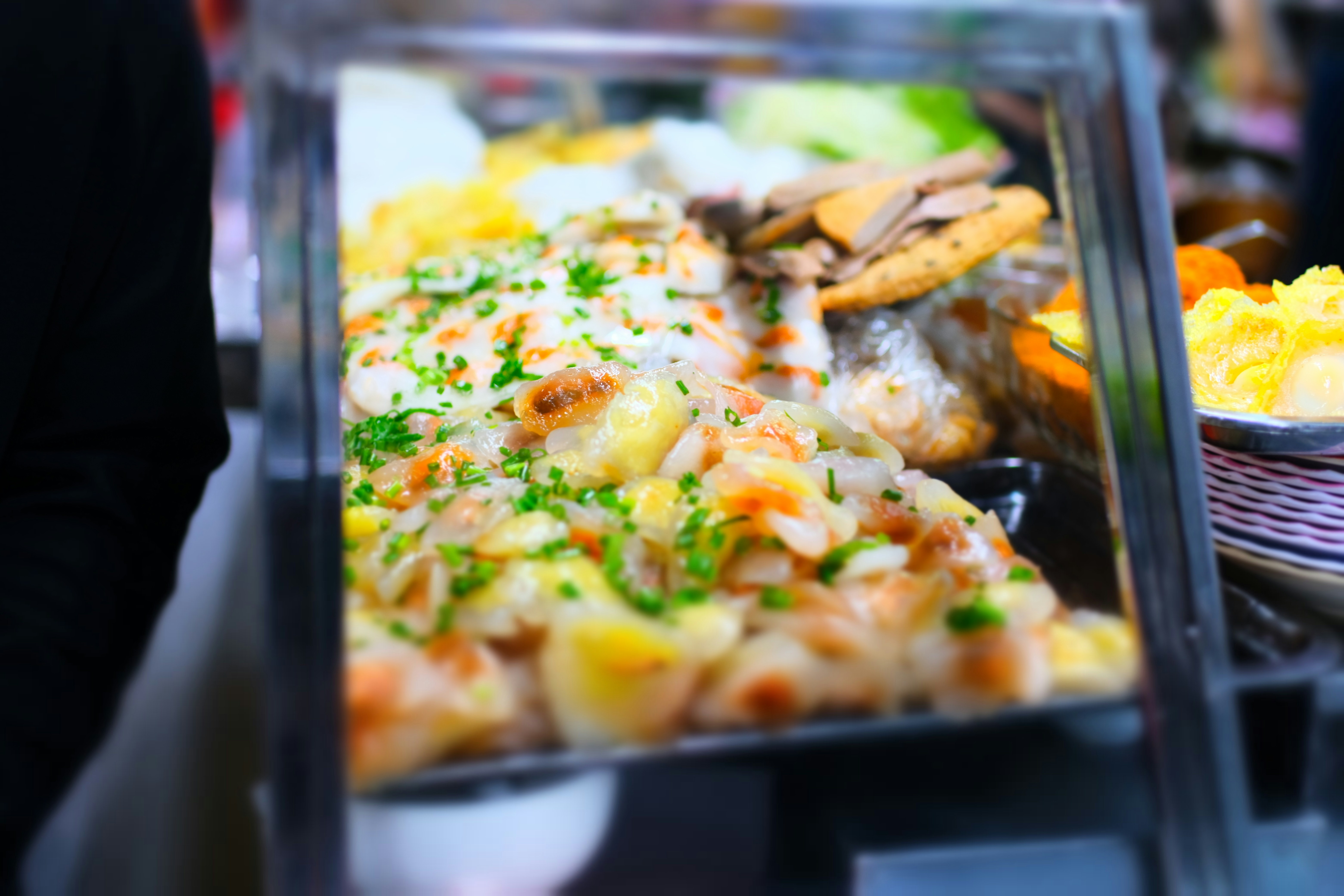 Delicious foods displayed in a glass food warmer.