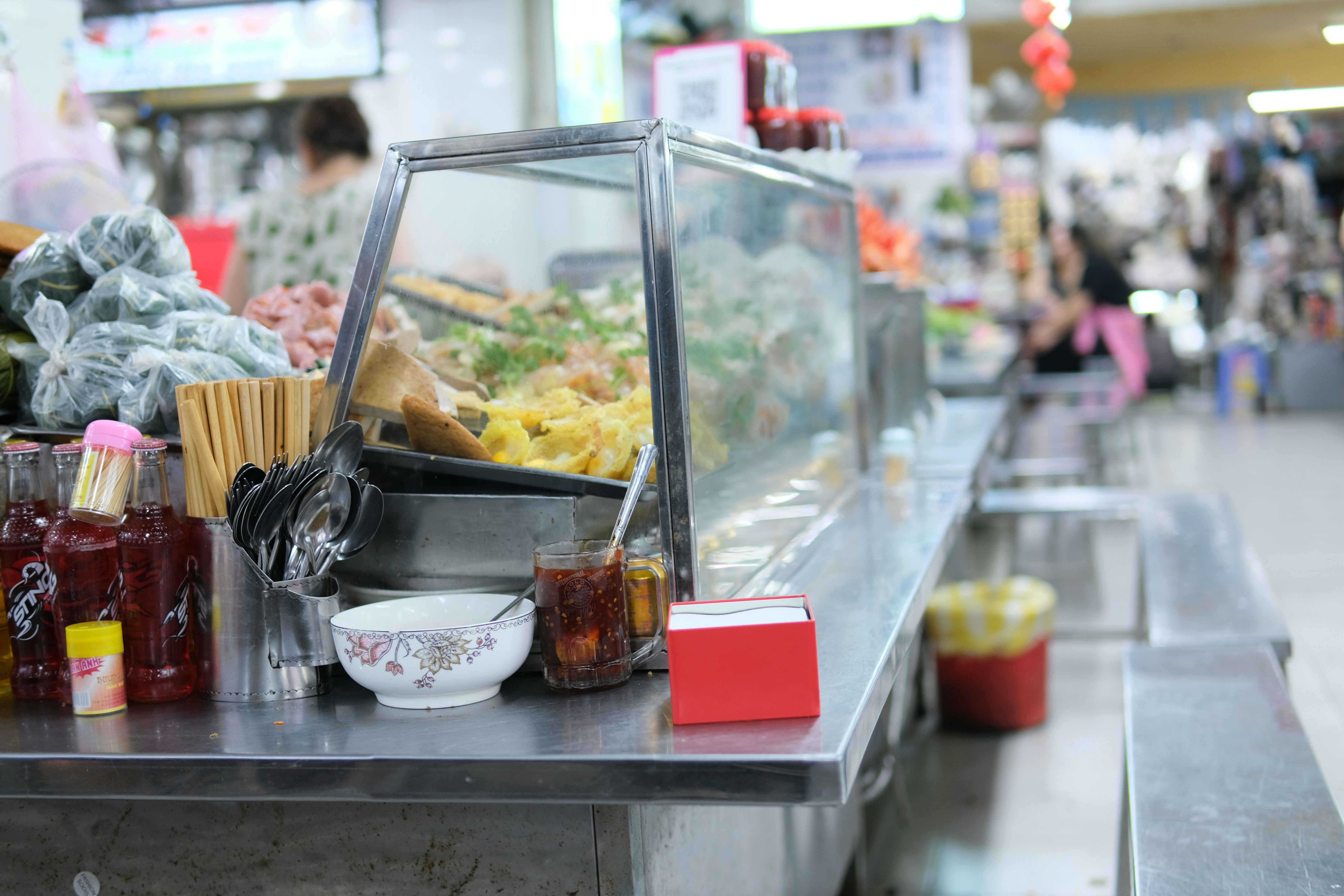 A food stall displays prepared dishes.
