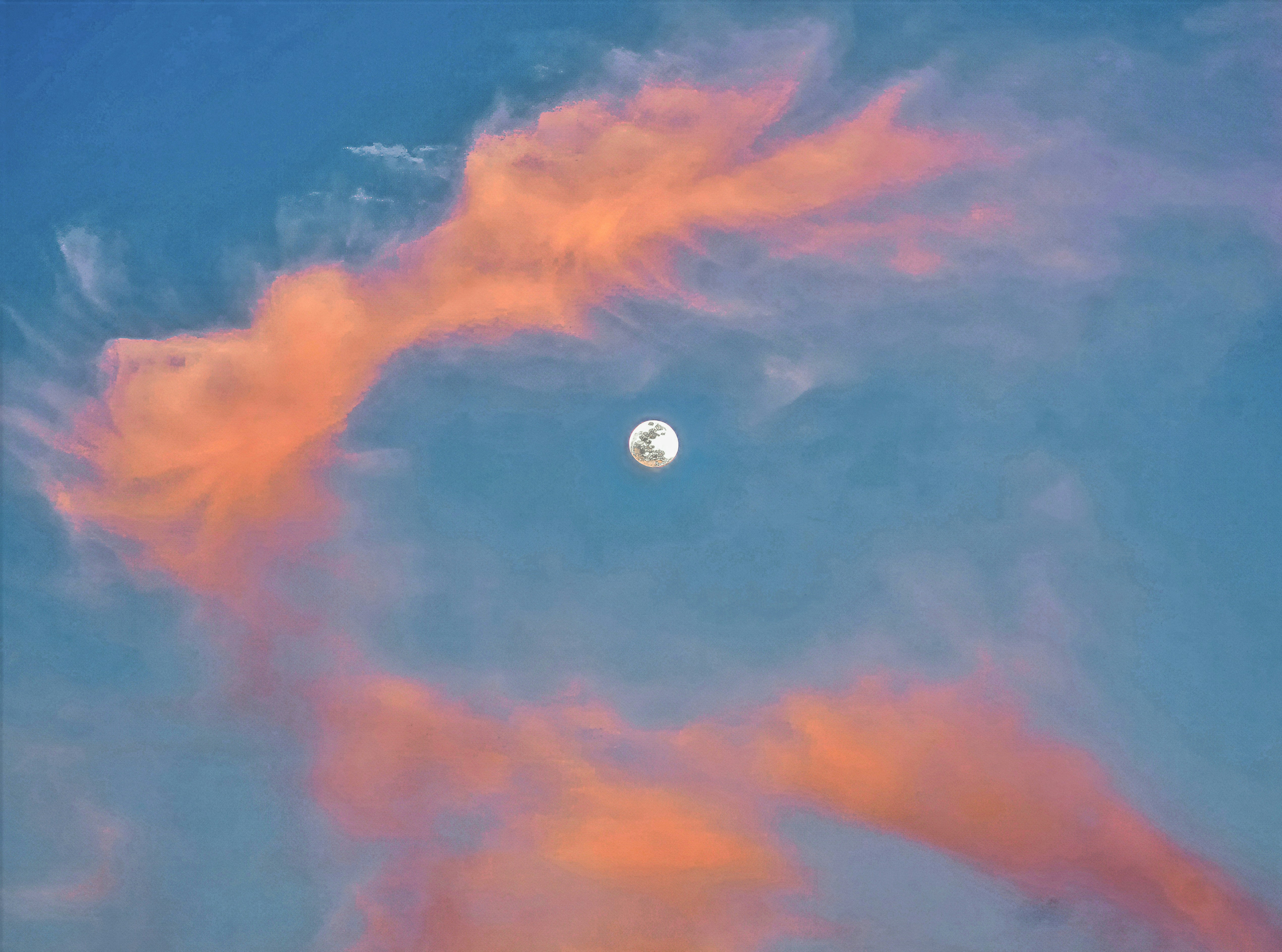 The moon shines through beautiful, fiery clouds.