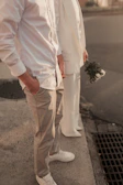 A couple waits patiently with white flowers.