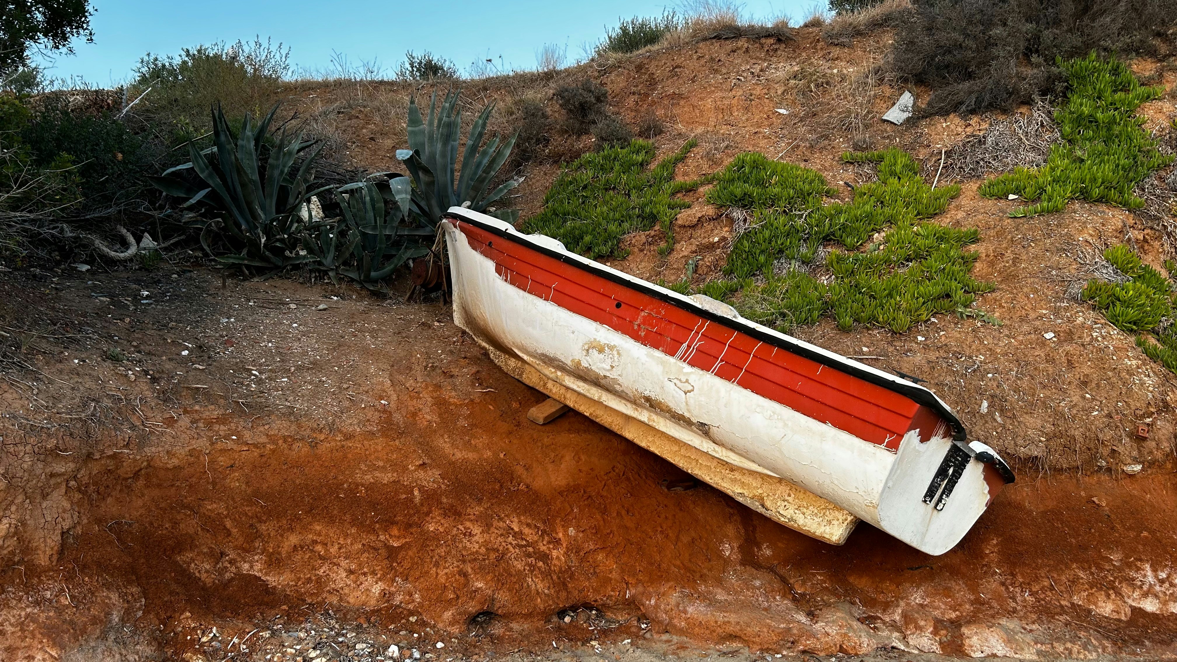 A small boat is resting on a hillside.