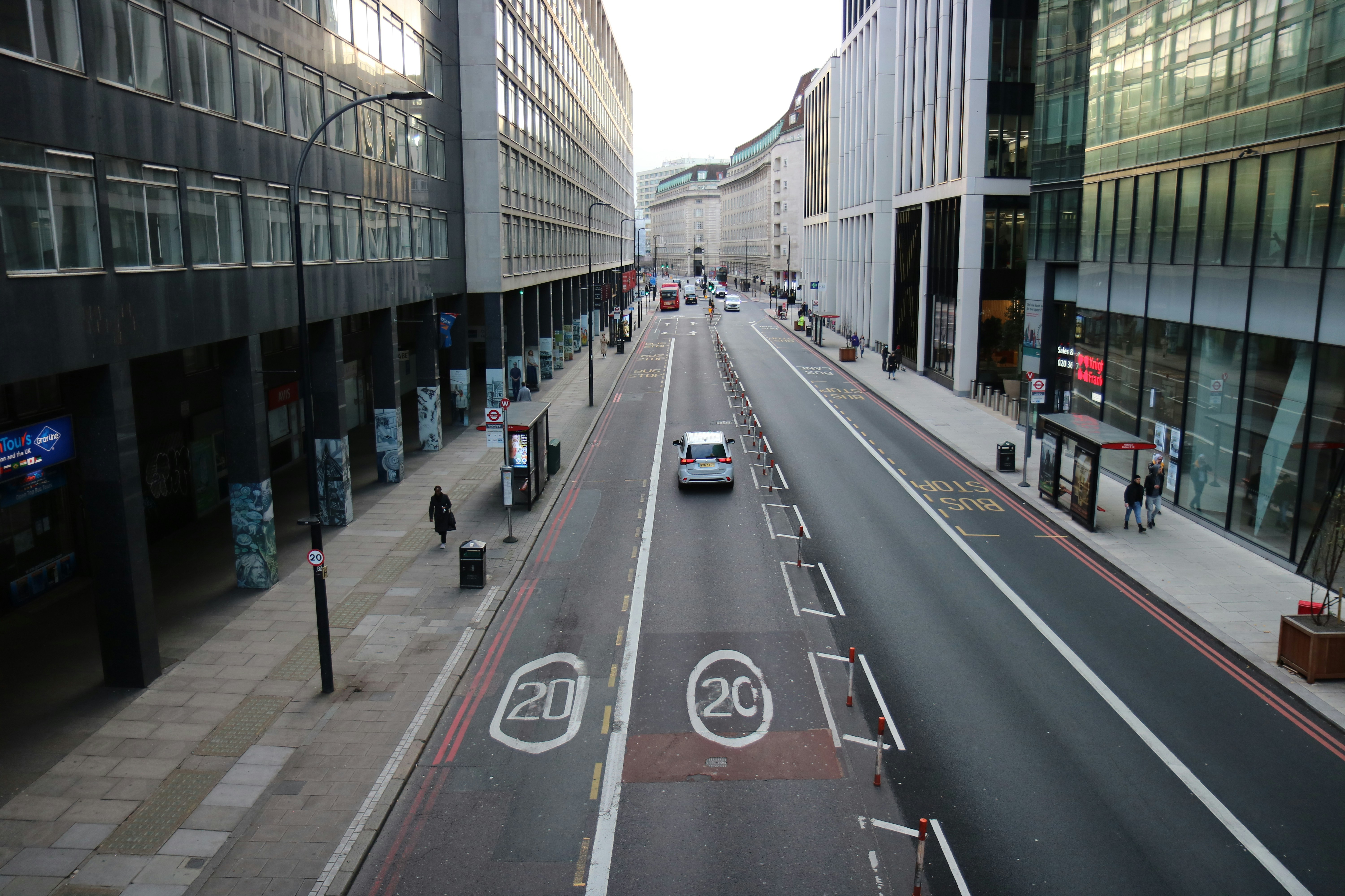 A city street with buildings and a car.