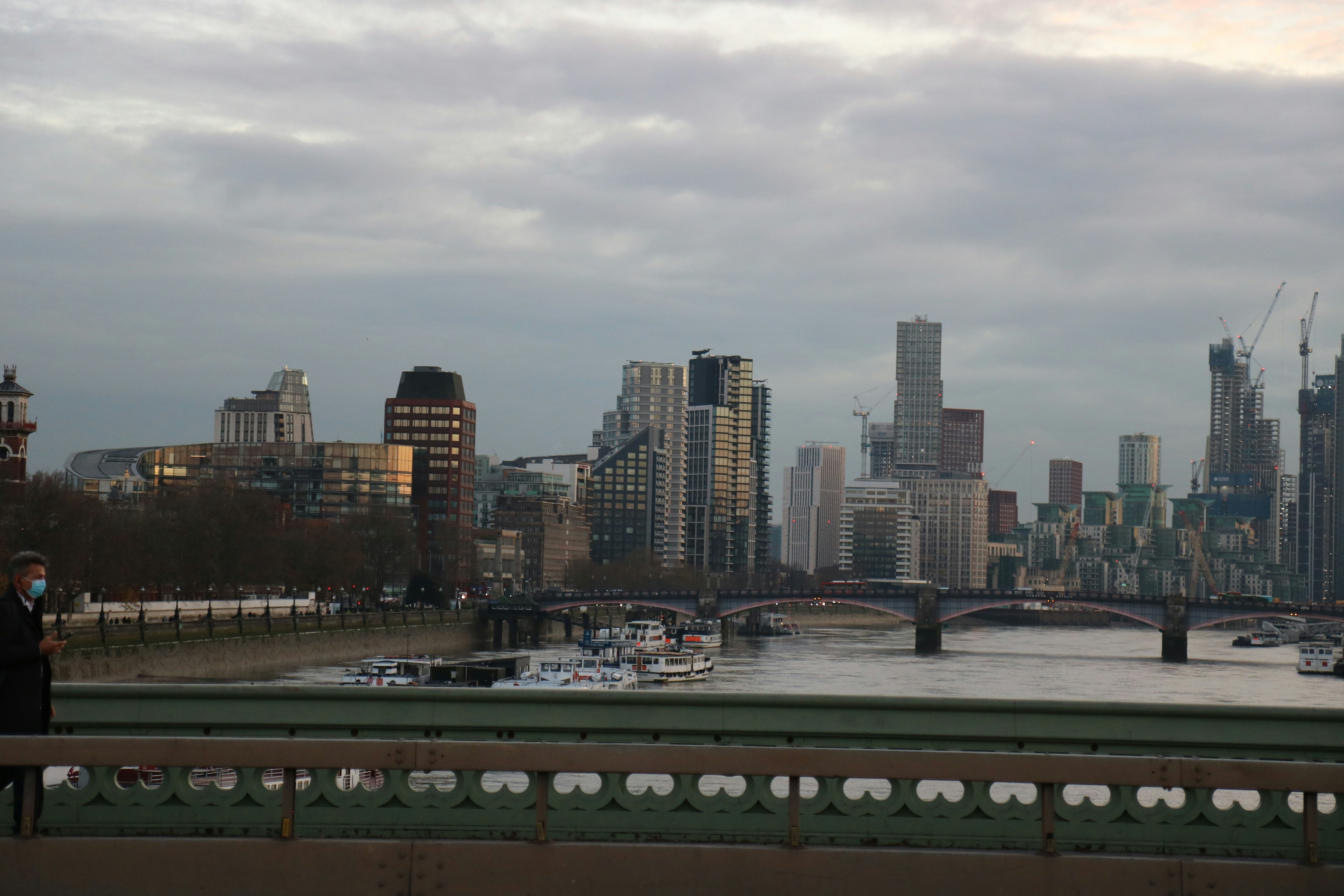 A cityscape of london under a cloudy sky.