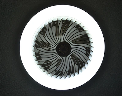 A circular fan with swirling blades.