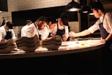 Chefs prepare food in a professional kitchen.
