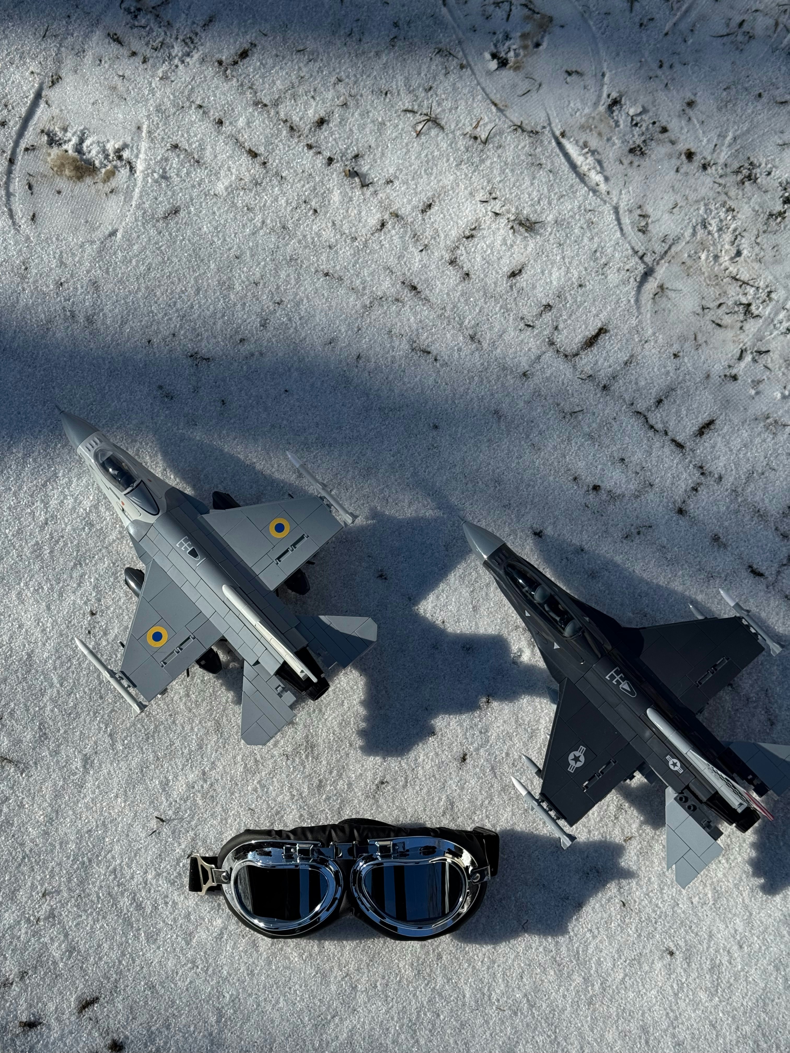Two jet fighters and goggles on snow.