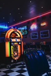 Retro diner interior with jukebox and neon lights.
