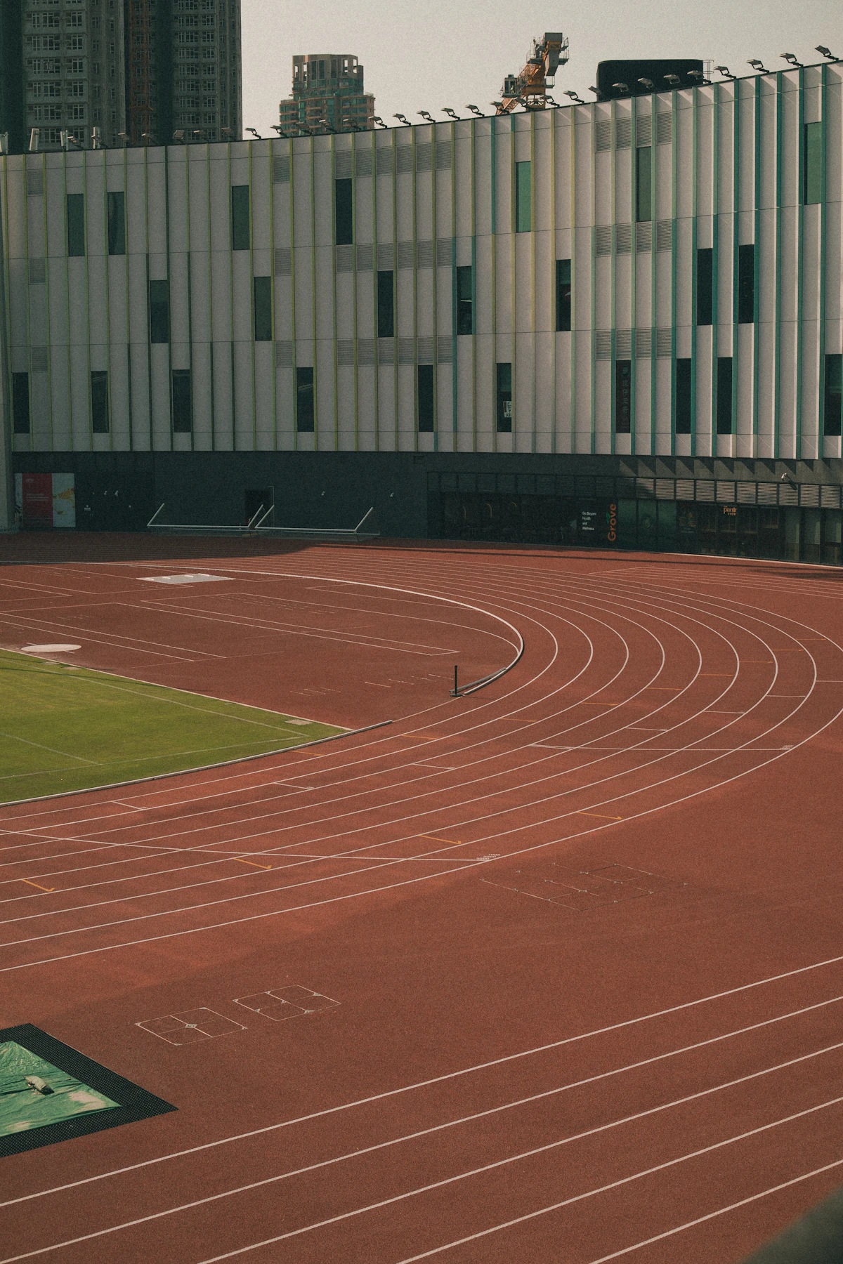 Empty curved athletics track with painted starting lines, no runners in frame
