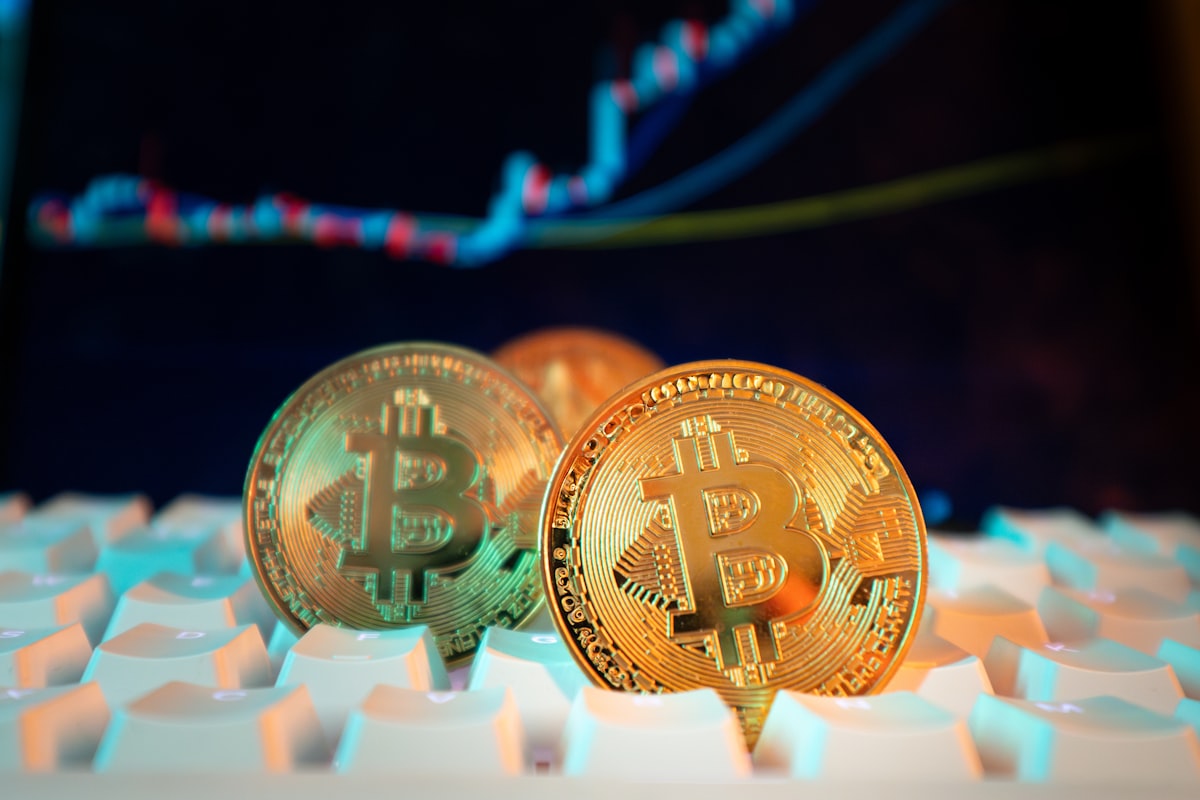 Bitcoin coins alongside stock market chart showing crypto market performance