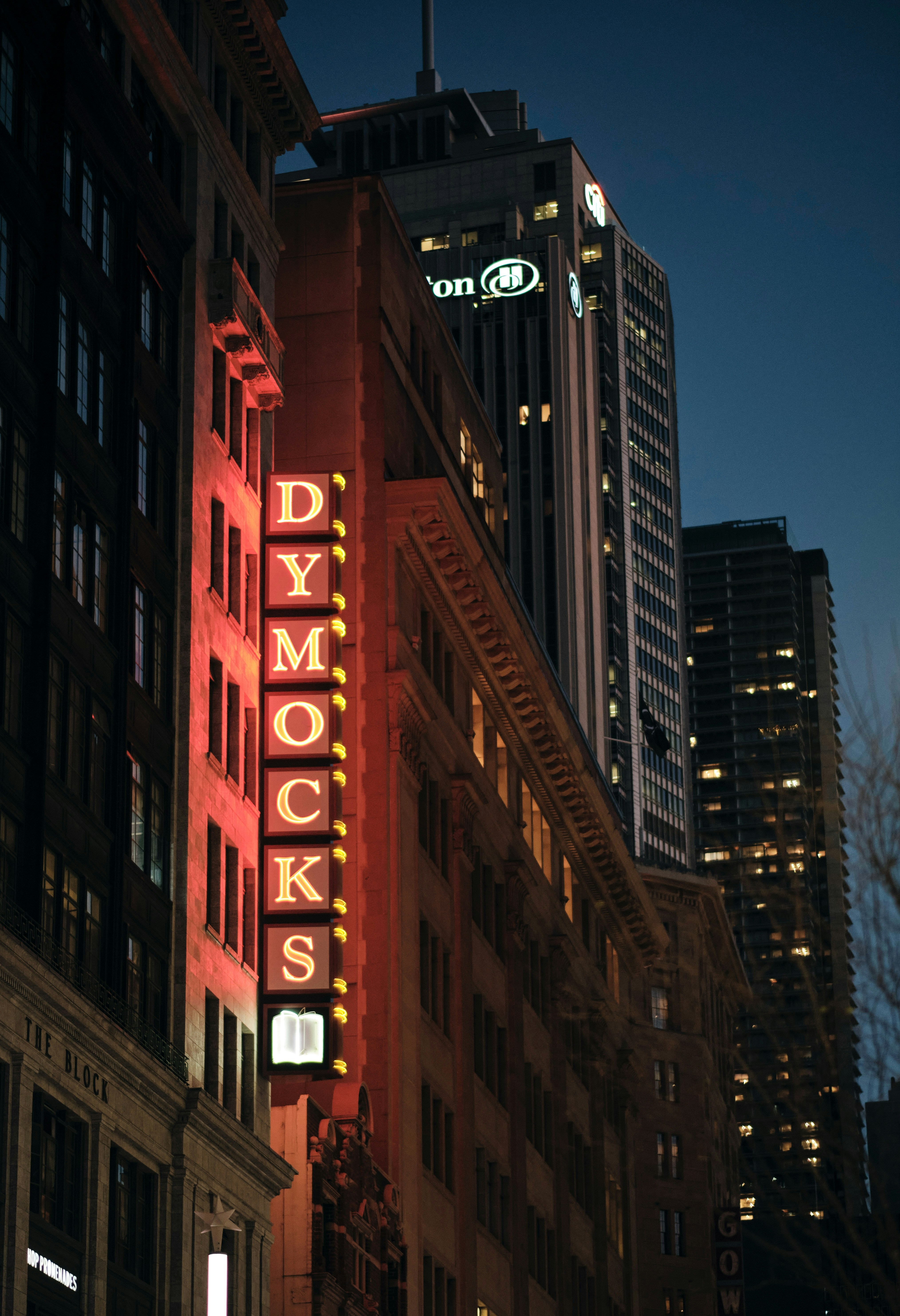 Dymocks bookstore sign glows in the nighttime.