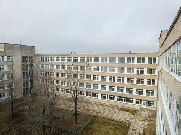 A large, grey building on a cloudy day.