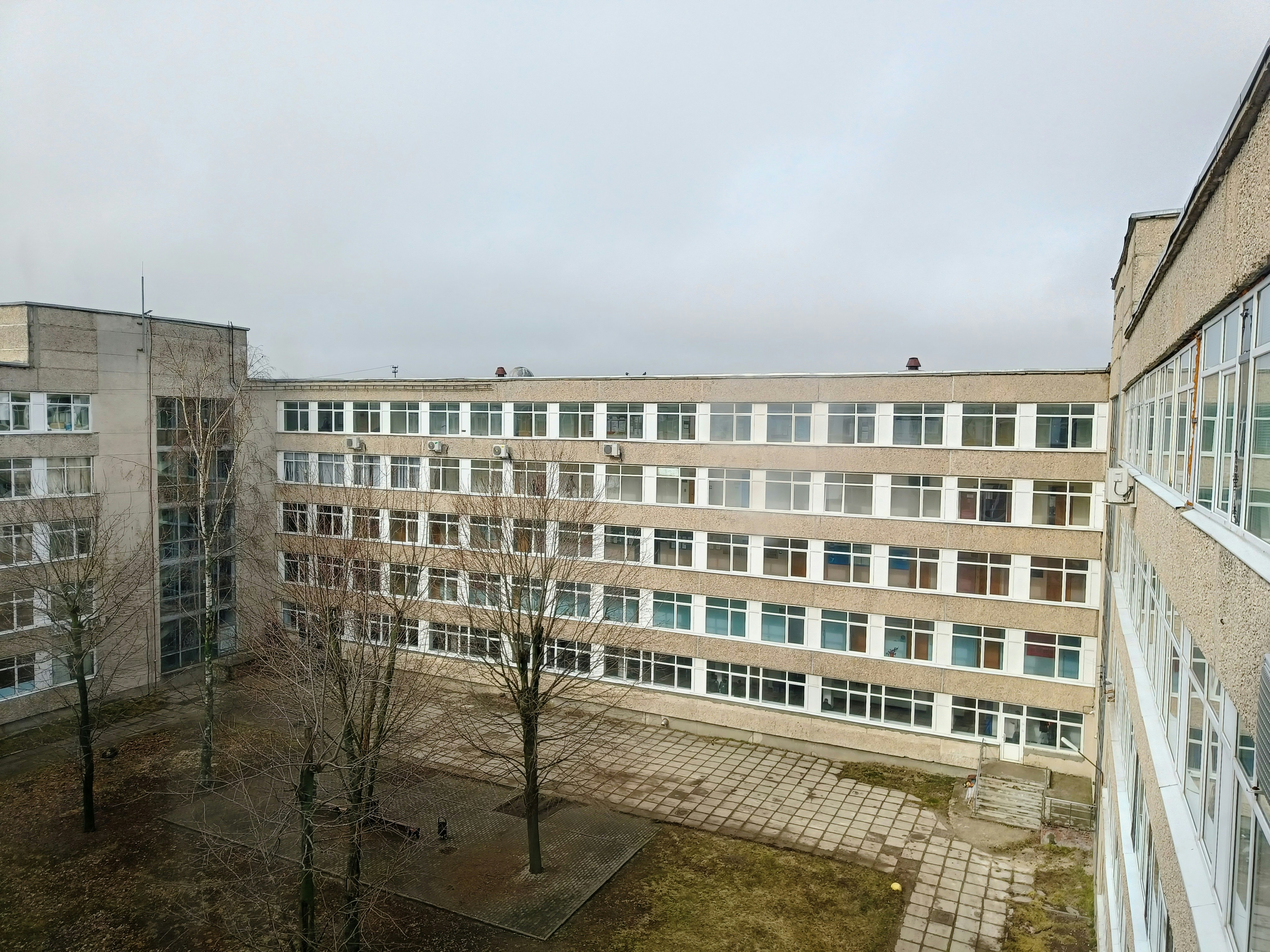 A large, grey building on a cloudy day.