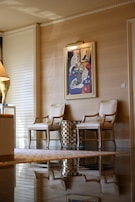 Elegant chairs and artwork create a luxurious space.