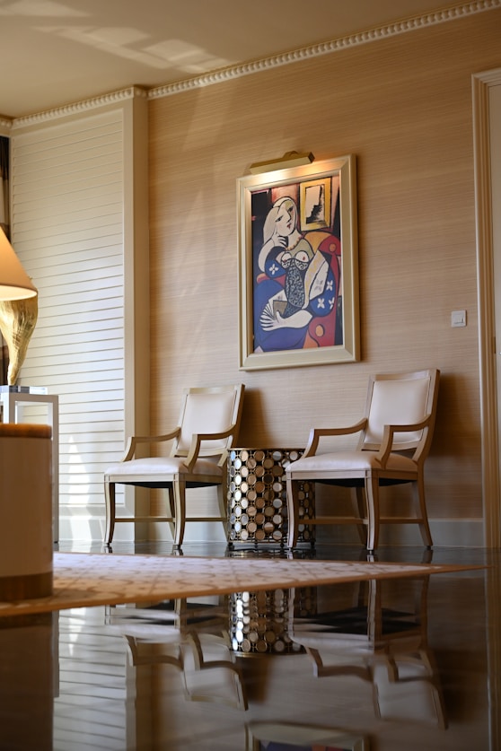 Elegant chairs and artwork create a luxurious space.