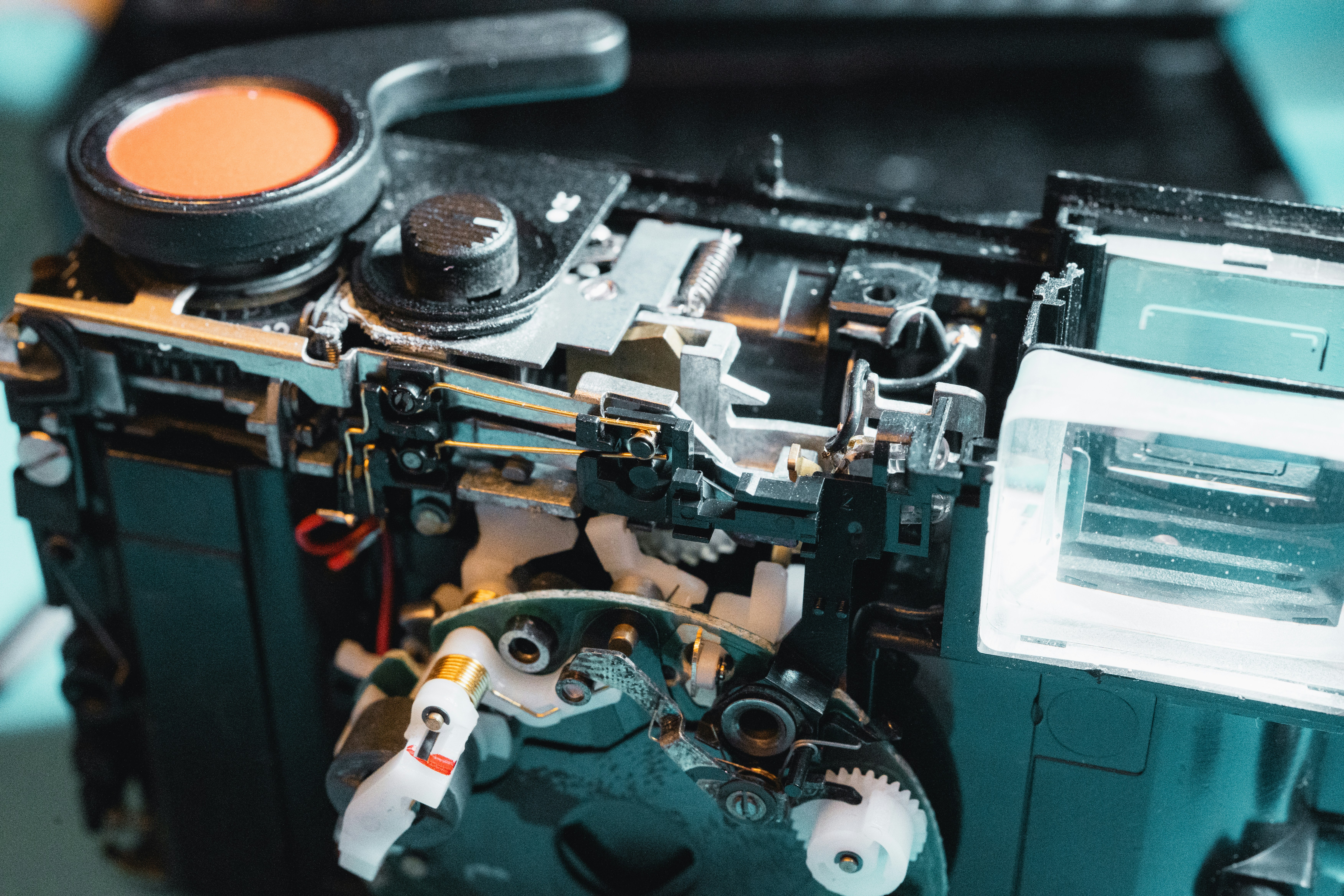 An old camera's internal mechanics are exposed.