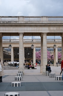 A classic french courtyard with people enjoying the day.