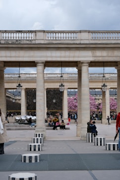 A classic french courtyard with people enjoying the day.