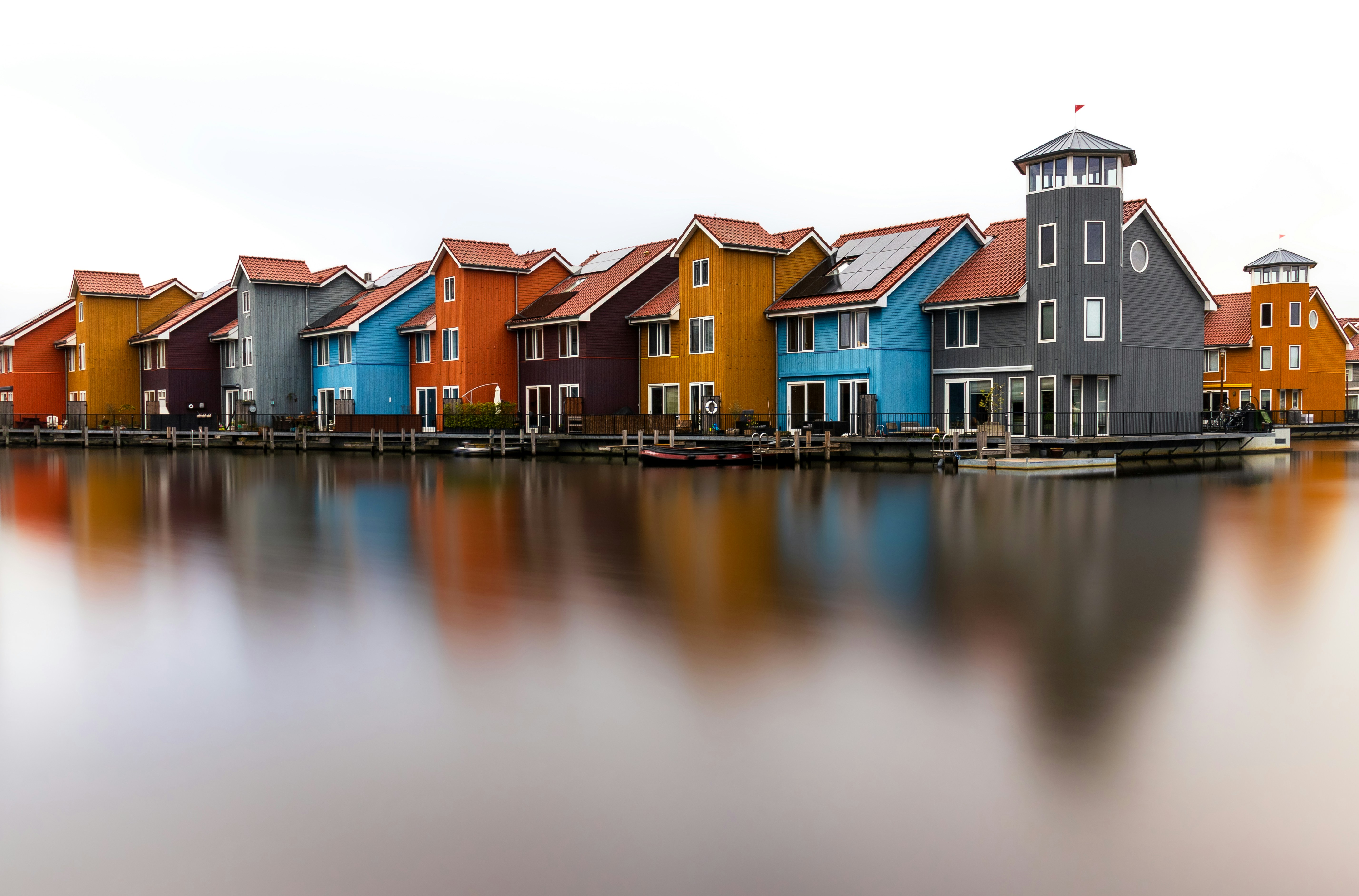Colorful houses line a peaceful waterway.