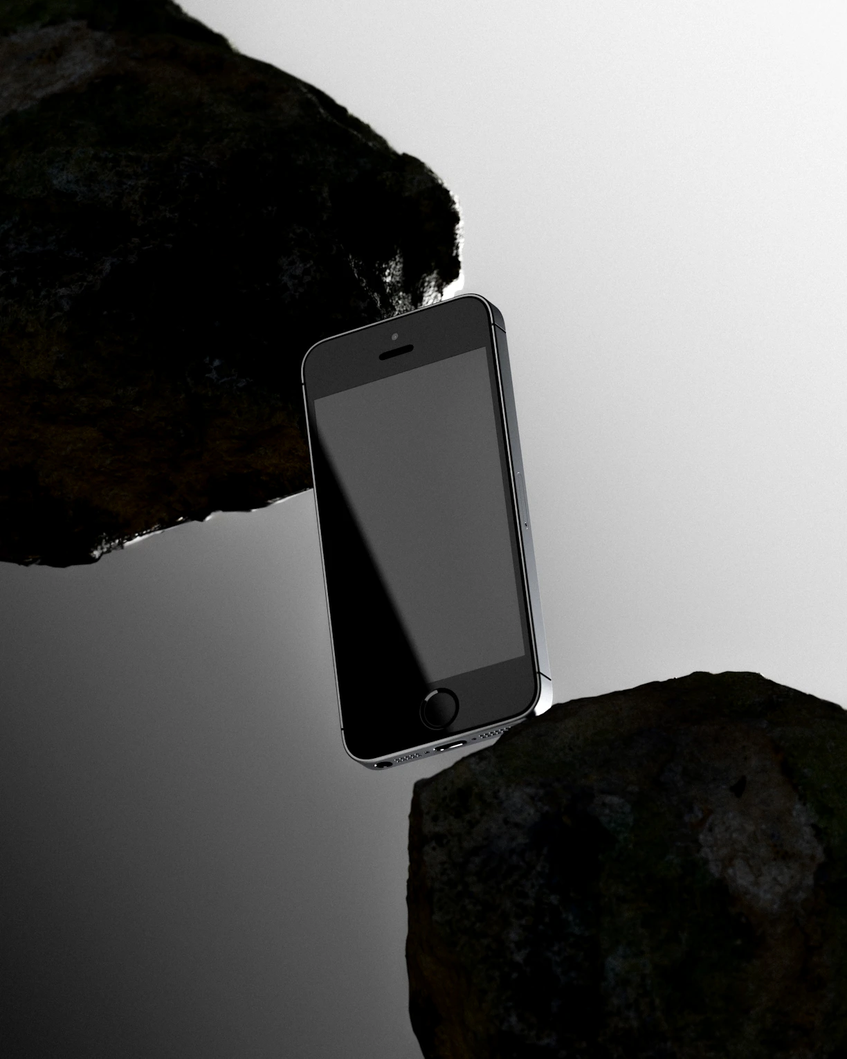 Smartphone suspended precariously between two rocks