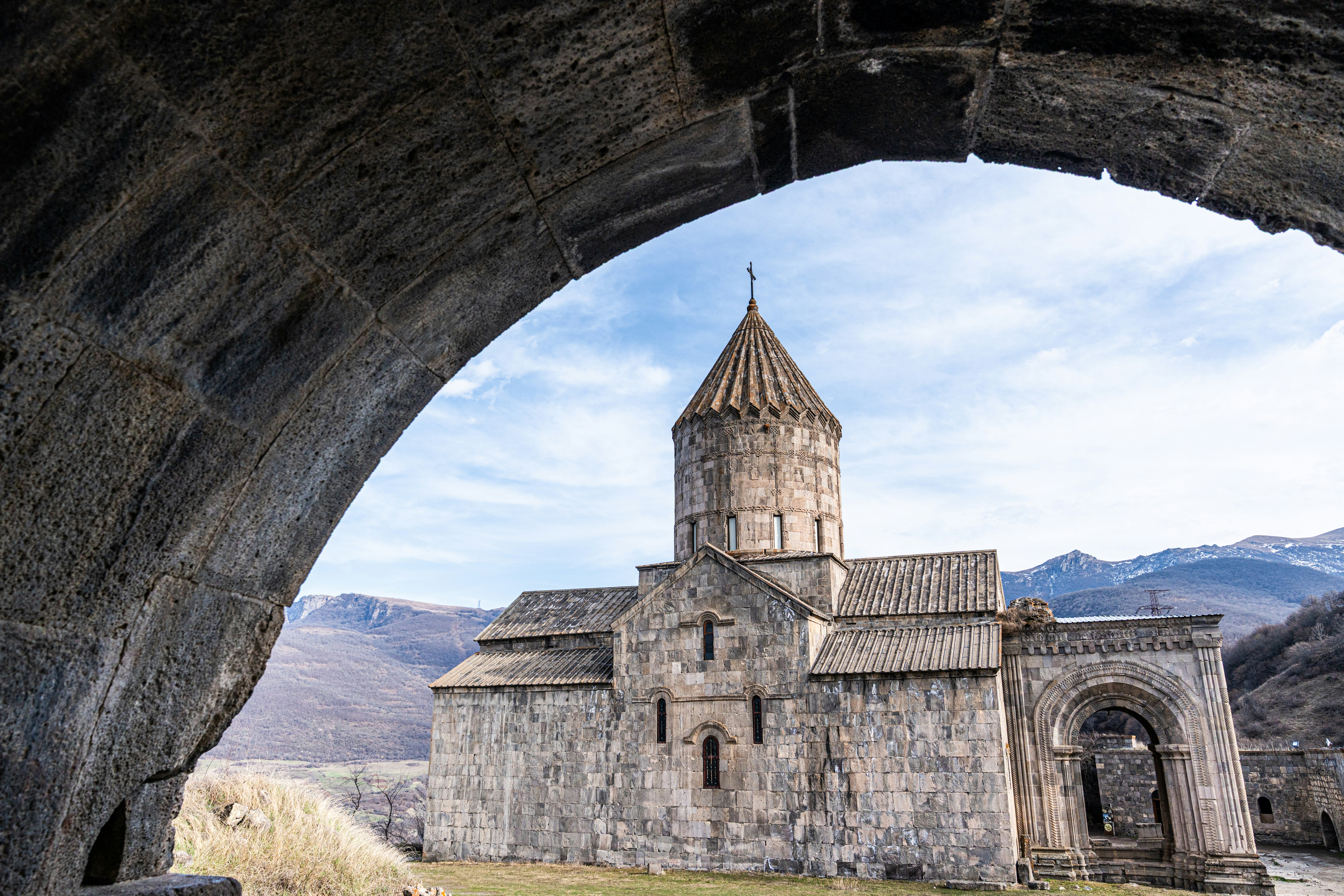Stone monastery in Armenia framed by an archway