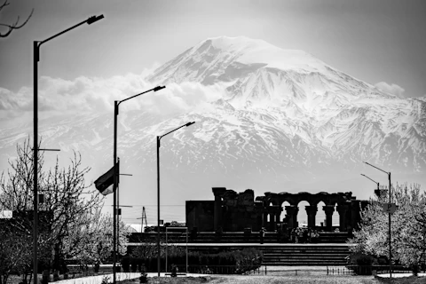 Ancient ruins and a mountain range are visible.
